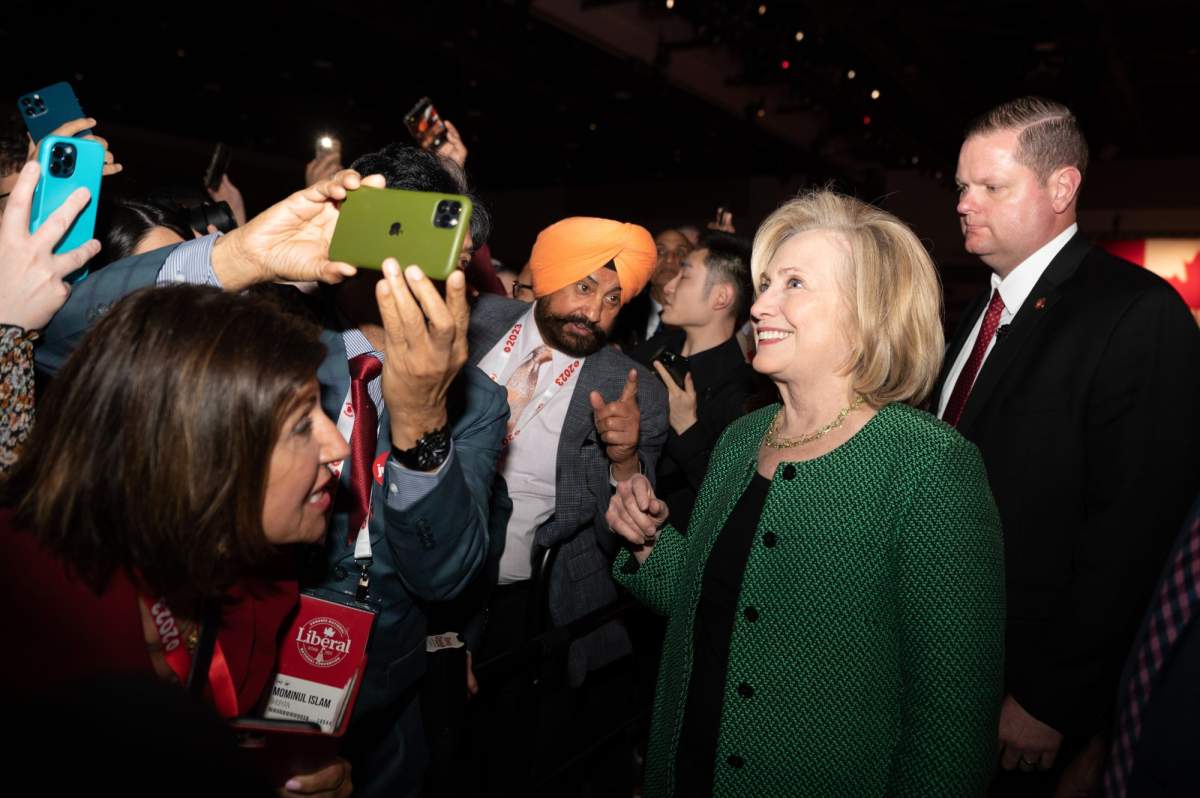 Former U.S. Secretary of State Hillary Clinton has a cell phone picture taken with participants after delivering a keynote address during the second day of the Liberal Convention in Ottawa, on Friday, May 5, 2023. THE CANADIAN PRESS/Spencer Colby