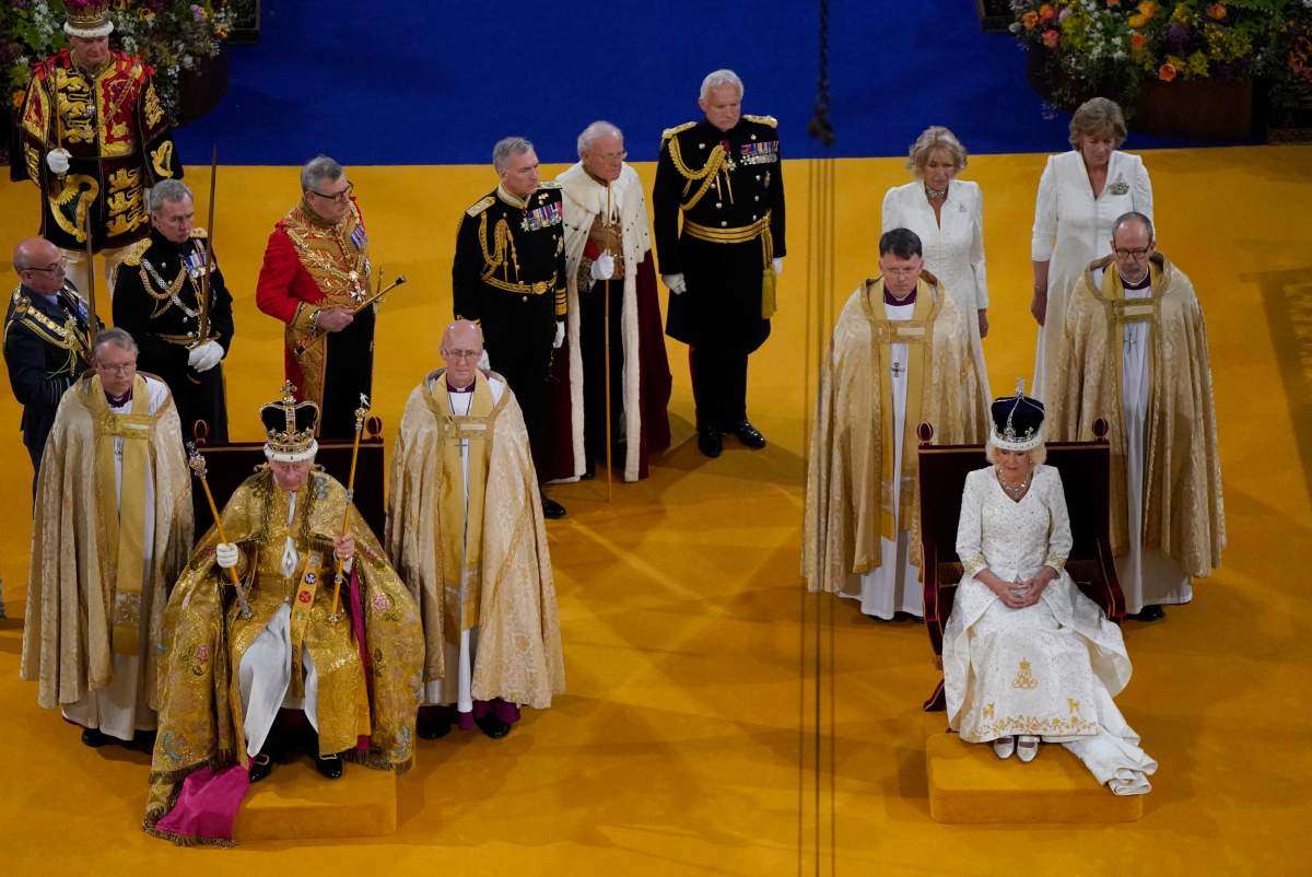 King Charles III wearing the St Edward’s Crown and Queen Camilla wearing the Queen Mary’s Crown sit during the coronation ceremony at Westminster Abbey, in London, Saturday May 6, 2023. (Andrew Matthews/Pool via AP)