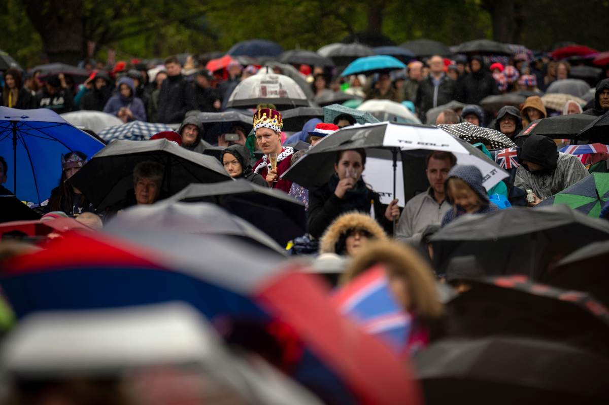 Royal fans watch the Britain’s King Charles III coronation ceremony on a screen in Hyde park, in London, Saturday, May 6, 2023. (AP Photo/Emilio Morenatti)