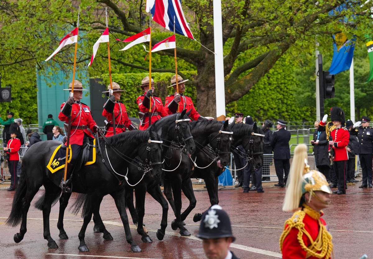 Royal Canadian Mounted Police officers ride in front of King Charles lll and Queen Camilla’s carriage during the Royal Procession following the King’s Coronation, in London on Saturday, May 6, 2023. THE CANADIAN PRESS/Nathan Denette