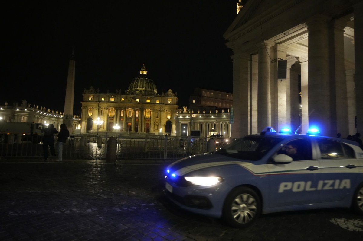 An Italian police car passes in front of St. Peter's Square at the Vatican, late Thursday, May 18, 2023. A car driven by someone with apparent psychiatric problems rushed through Santa Anna gate Thursday evening and sped past Swiss Guards into a palace courtyard before the driver was apprehended by police. Vatican gendarmes fired a shot at the speeding car's front tires after it rushed the gate, but the vehicle managed to continue on its way, the Vatican press office said in a statement late Thursday. (AP Photo/Andrew Medichini).