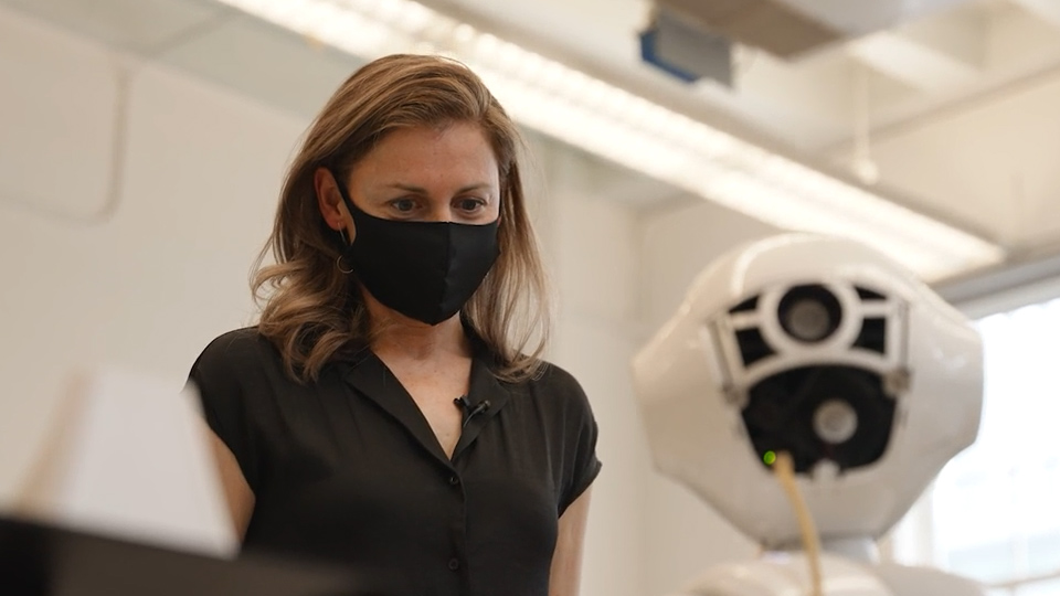 PhD canidate Cristina Getson showing how Pepper, the health-screen robot, works