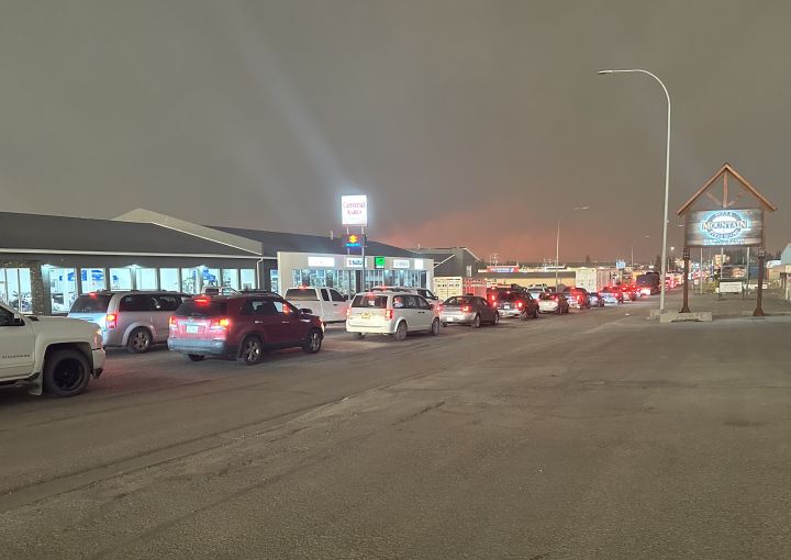 Vehicles seen leaving Edson, Alta., after a wildfire prompted an evacuation order for the town on May 5, 2023.