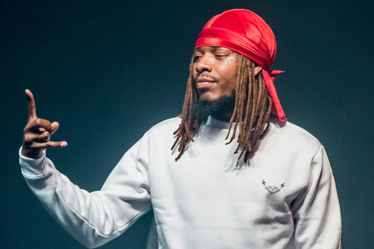 Fetty Wap in a grey sweater and red durag.