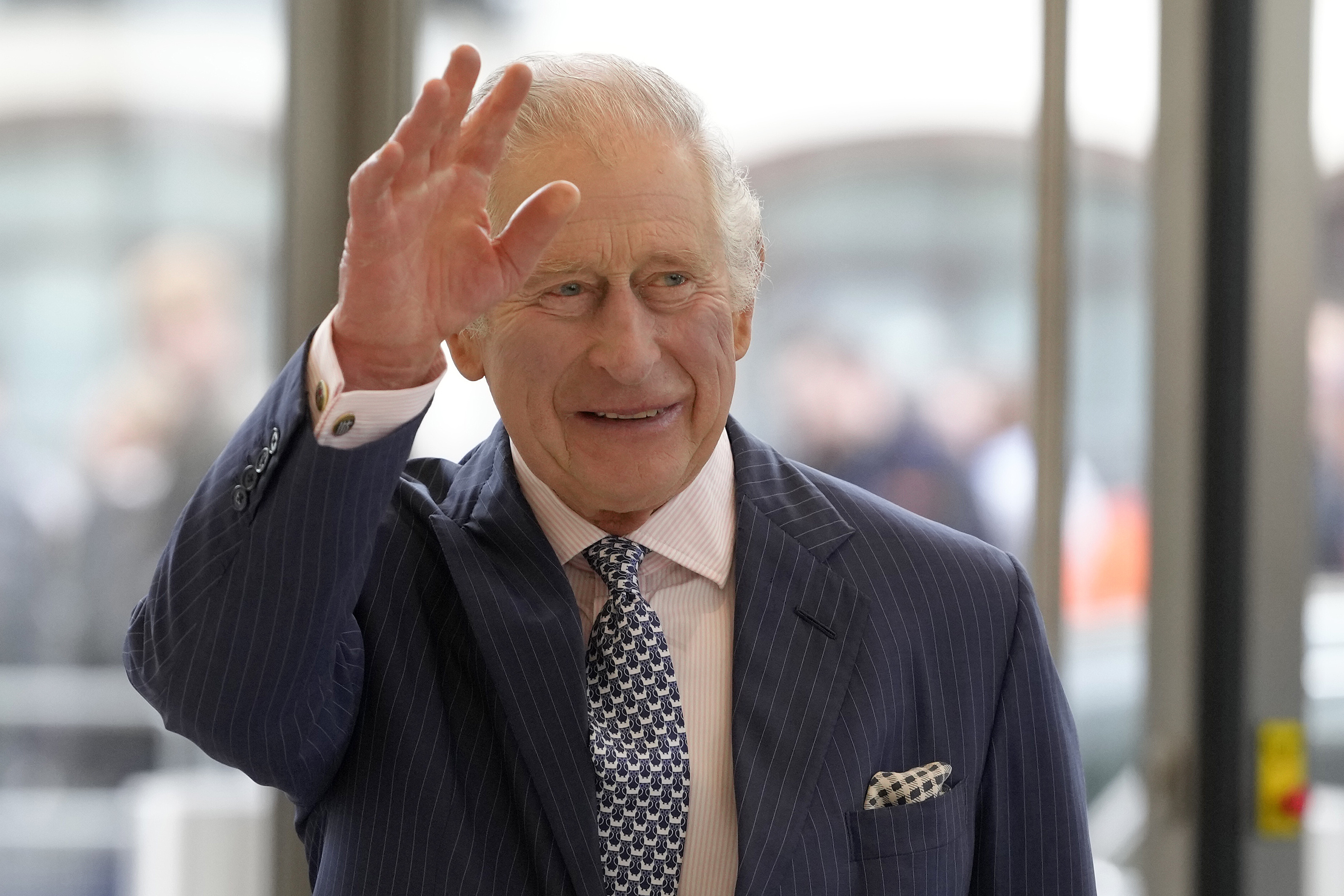 Britain's King Charles III waves to a crowd in London, Thursday, March 23, 2023. King Charles' Coronation is May 5, 2023.