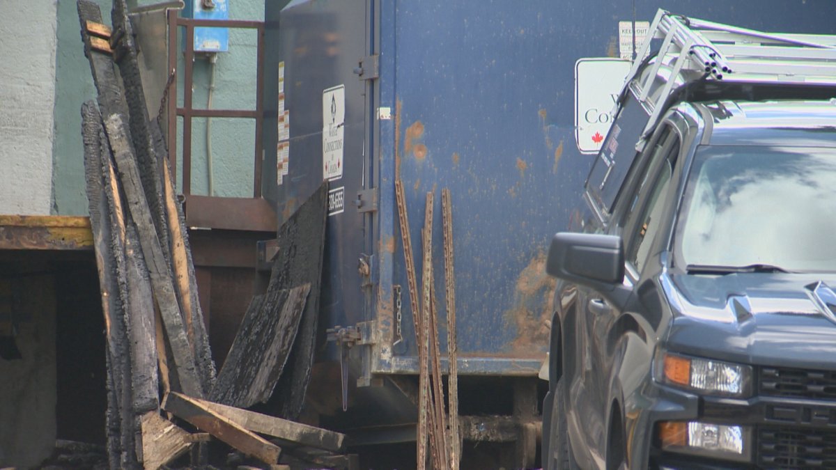 A pile of burnt wood sits on the loading dock of the Sandman Signature hotel in Lethbridge on May 29, 2023. Police have charged one man in connection to a pair of fires.