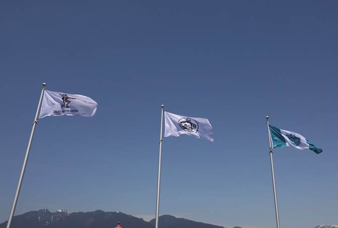 The flags of the Musqueam, Tsleil-Waututh and Squamish nations flying at Brockton Point in Stanley Park. 