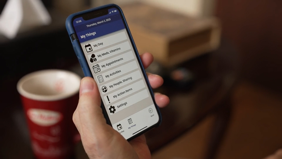 Paul showing us the interface of the MAXminder app
