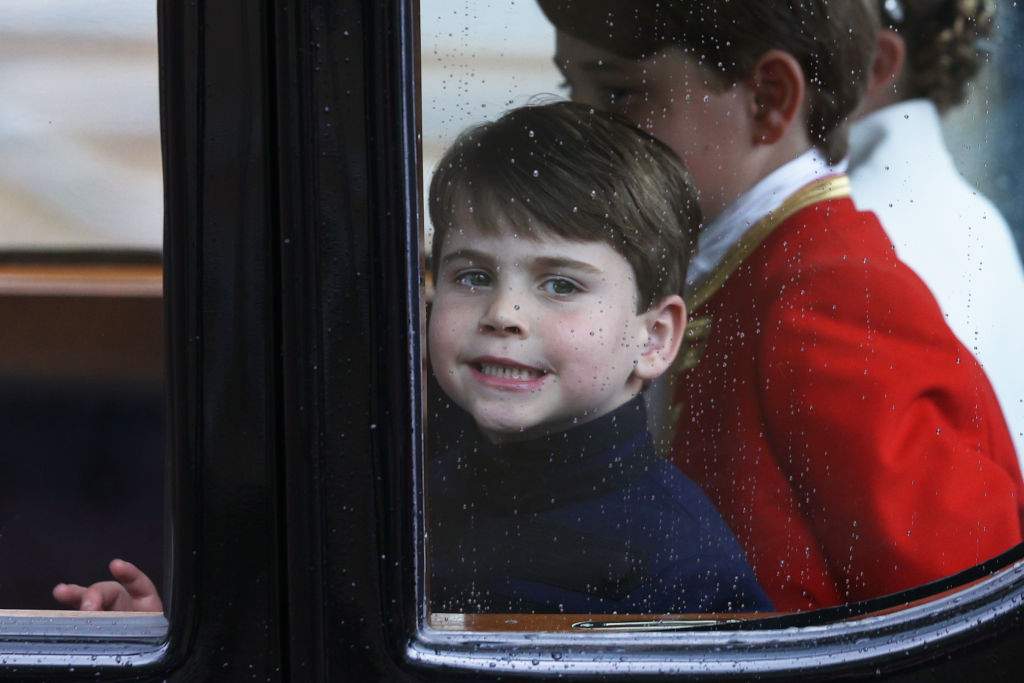 LONDON, ENGLAND - MAY 06: Prince Louis of Wales smiles through the window as he travels with his family back to Buckingham Palace from Westminster Abbey on May 6, 2023 in London, England. (Photo by Adrian Dennis - WPA Pool/Getty Images)