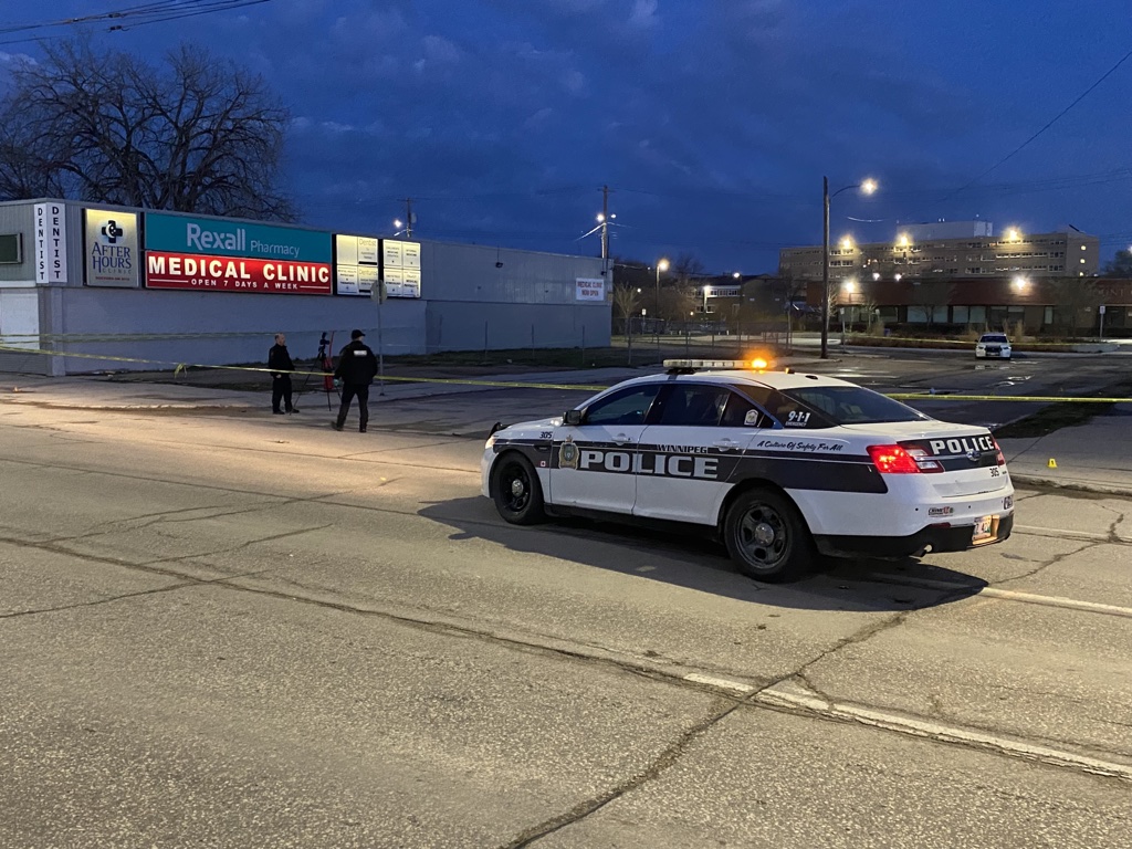 Winnipeg police investigate a crime scene at Stella Avenue and Main Street in May. A Winnipeg man is facing numerous charges for breaking and entering a string of automotive shops throughout the summer.