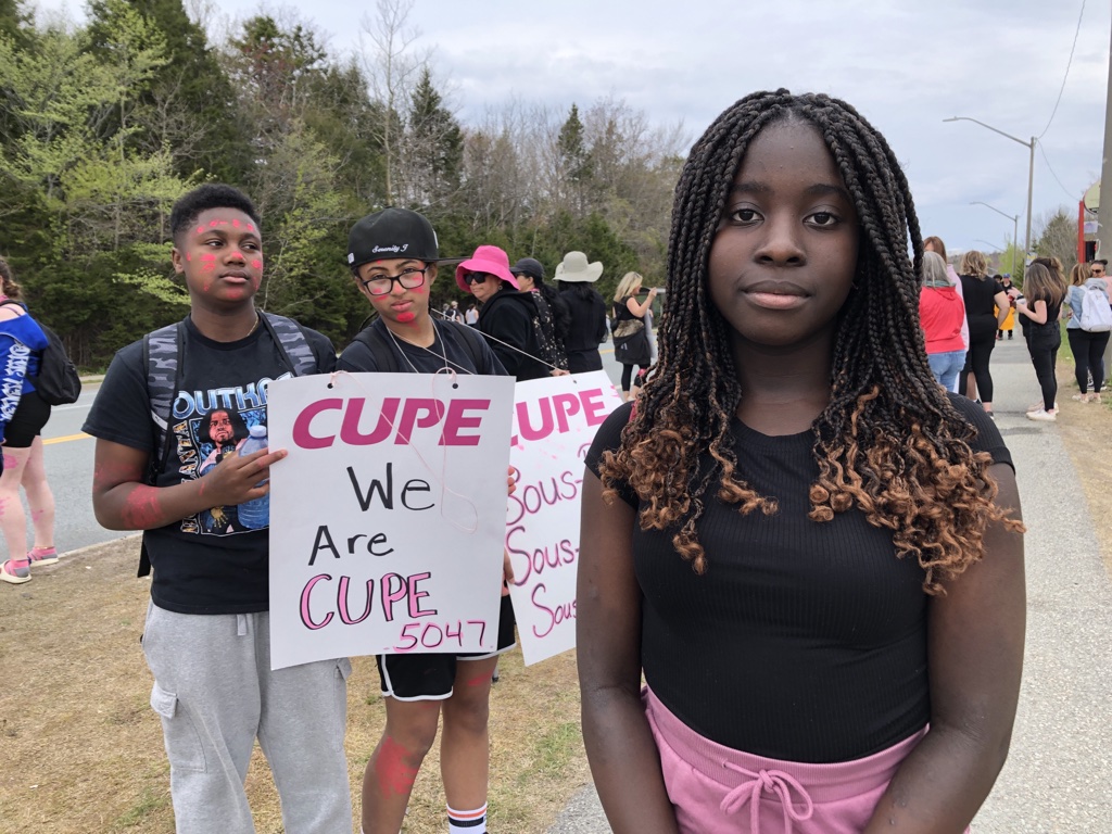 Sackville High Grade 9 Student Moriah Aladejebi stands with striking support workers in Lower Sackville on Monday, May 15, 2023.