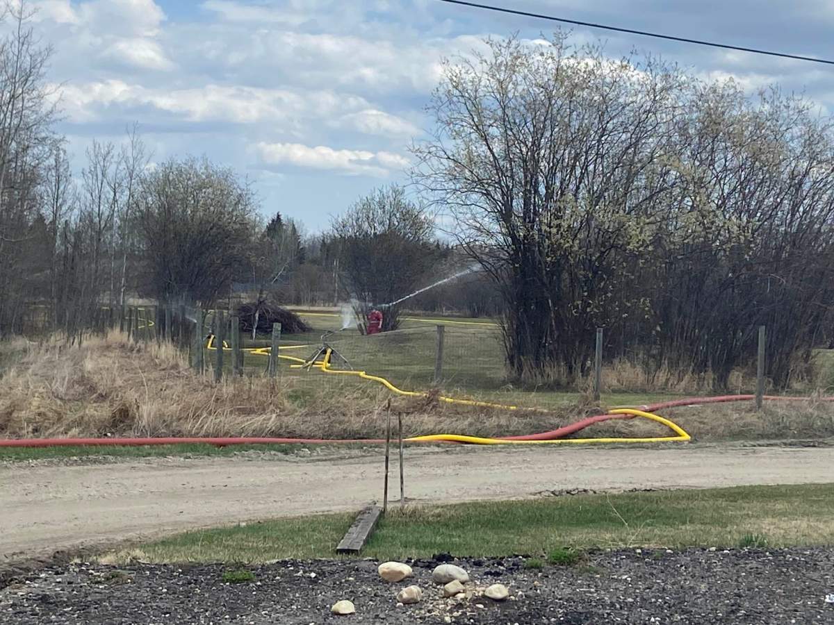 Firefighters are using Lobstick River as a water source to keep Wildwood wet. May 2, 2023.
