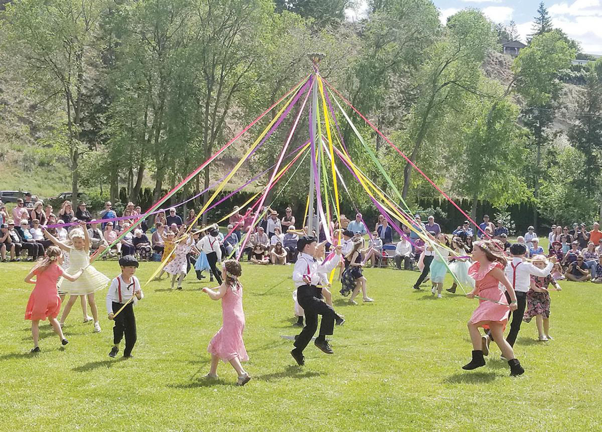 Children dance around the May Pole at the 2019 festival.