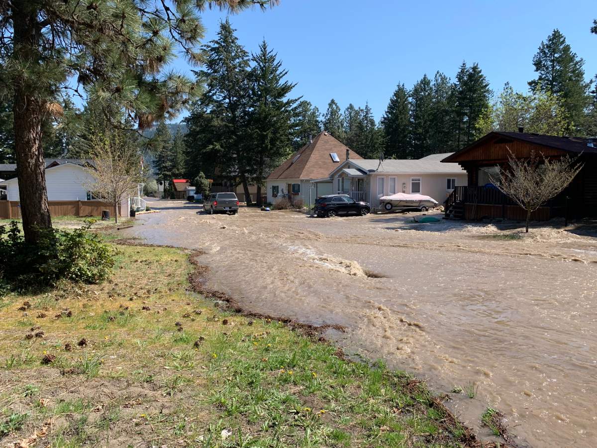 Surging water from Whiteman’s Creek flowed in Falcon Ave. on Tuesday, May 2, 2023.