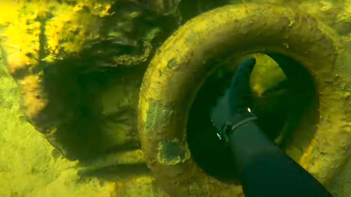 A screenshot of Penticton, B.C., resident David Pennylegion picking up a tire during one of his dives to clean up local waterways.