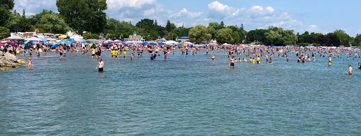 Thousands flock to Victoria Beach in Cobourg, Ont., during the Sandcastle Festival. The town is offering a season waterfront parking pass for non-residents.