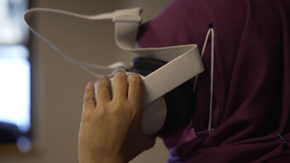 Onatrio Tech Uni grad student Farzana Rahman demos a VR headset