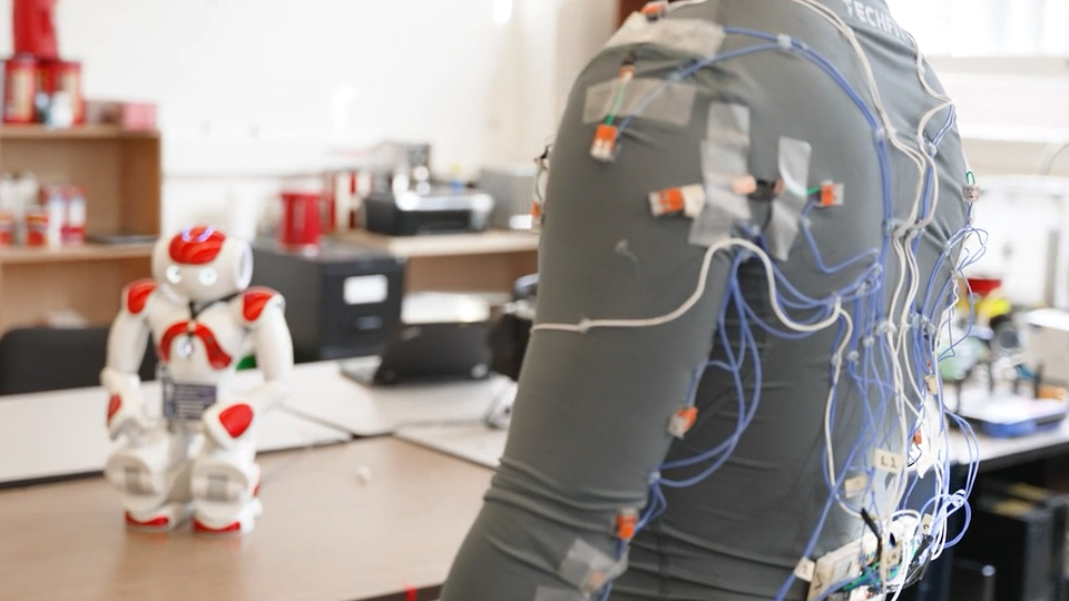 Zinan Cen showing us the wires on the back of his smart clothing wearable for older adults