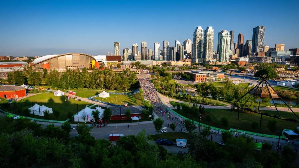 Runners make their way next to Enmax Park in the first kilometres of the 2023 Calgary Marathon.