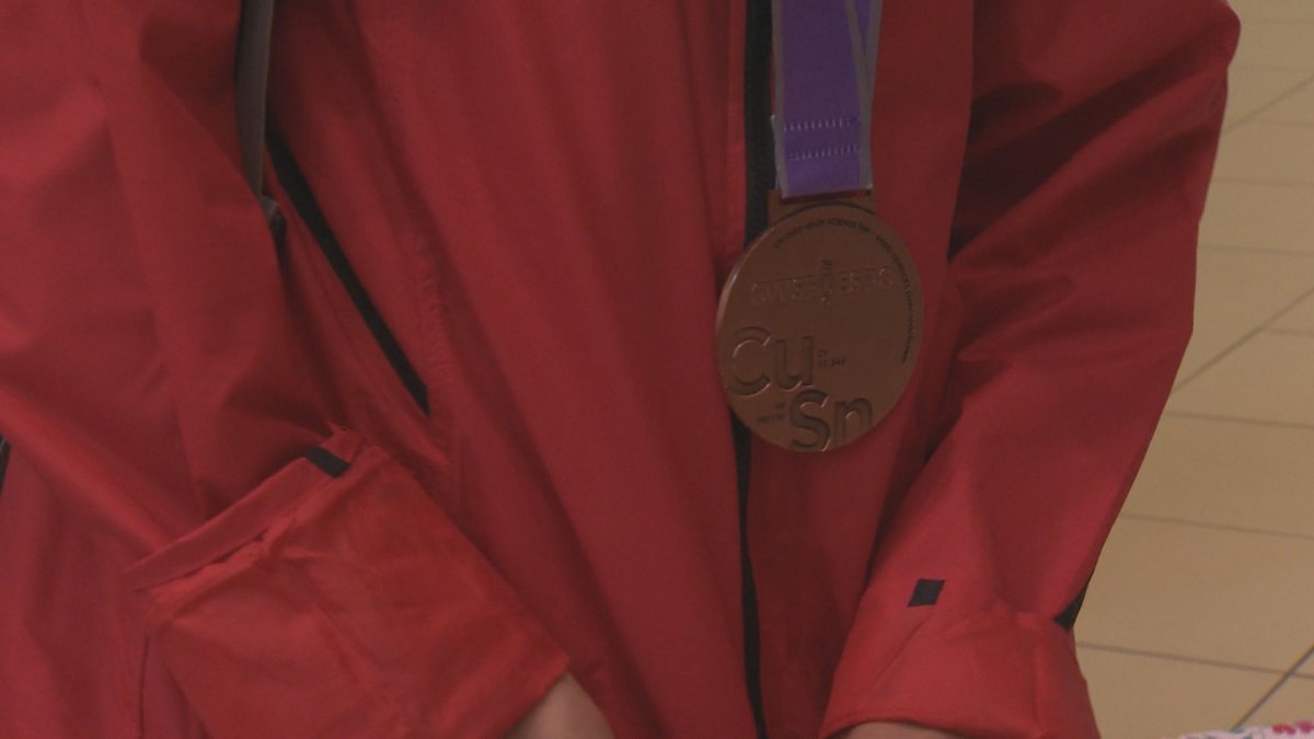 a bronze medal on a red jacket