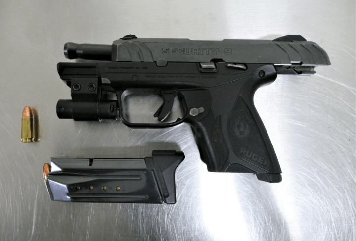Police say a loaded illegal handgun was found wrapped in a sweater in a closet next to a crib.