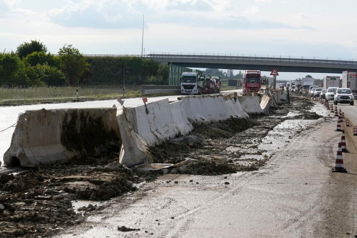 Trucks and cars queue in a damage highway in Forli, Italy, Thursday, May 18, 2023. (AP Photo/Luca Bruno)