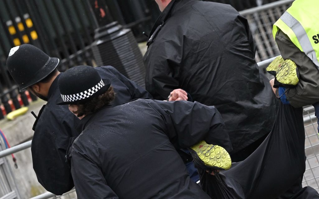 Police officers take away a protester close to the ‘King’s Procession’, a journey of two kilometres from Buckingham Palace to Westminster Abbey in central London on May 6, 2023. (Photo by LOIC VENANCE / AFP) (Photo by LOIC VENANCE/AFP via Getty Images)