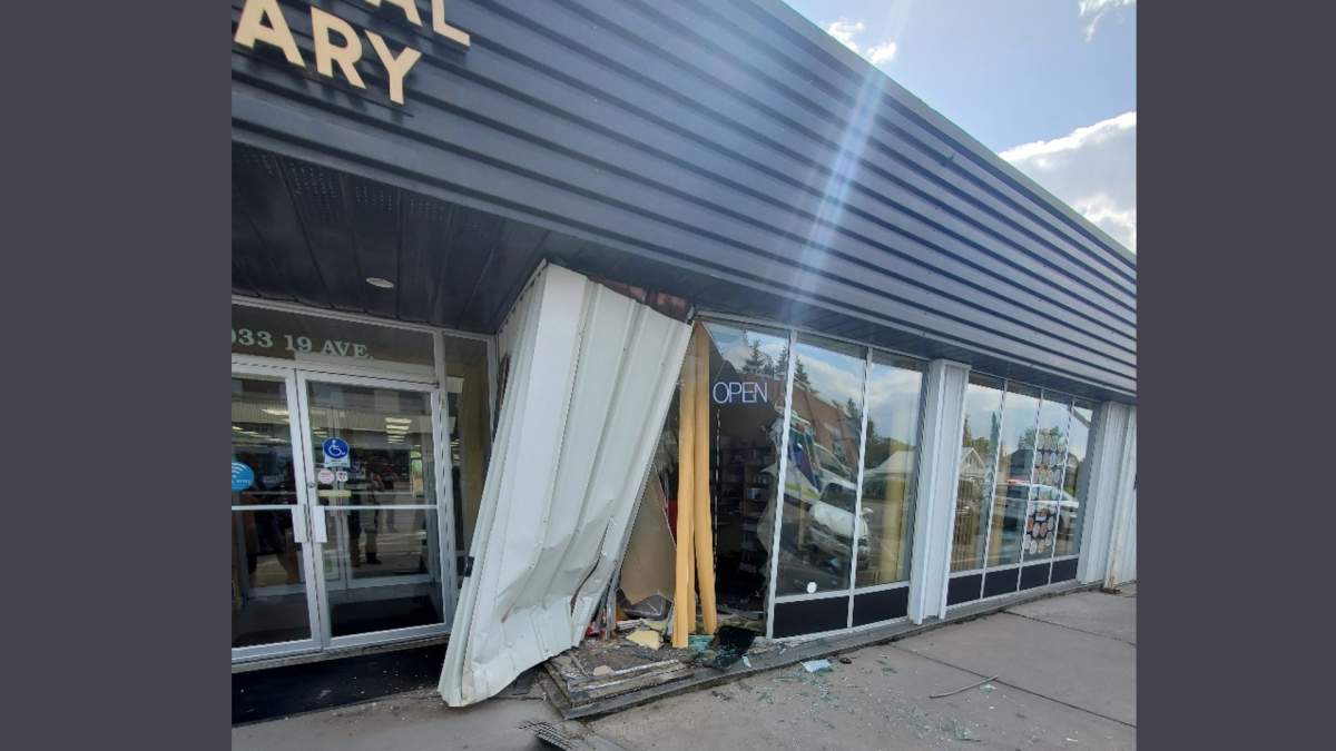 Damage to the front window of the Didsbury Municipal Library following a May 29 crash. (RCMP)