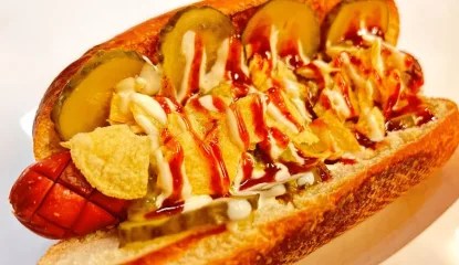 A hotdog with an infused smoked whisky sauce, dill pickles, together with a spicy, cheesy relish.