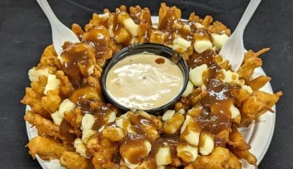 A classic Colossal Onion smothered with traditional cheese curds and topped with vegetarian gravy.