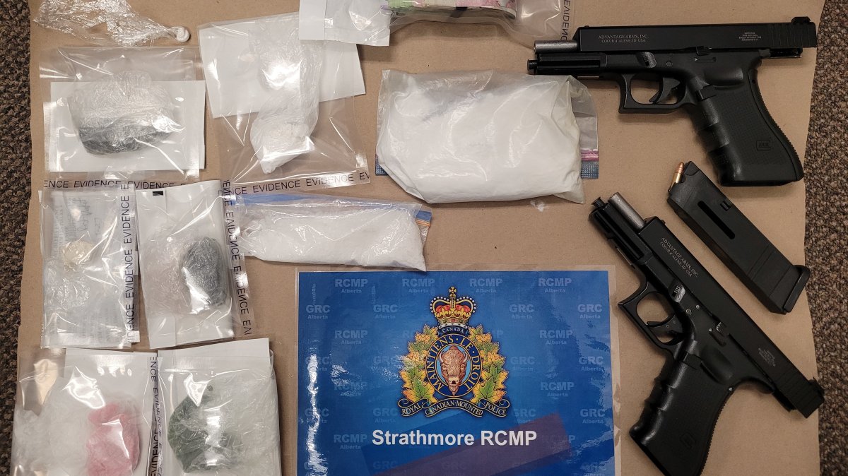 Drugs, handguns and cash seized from a Strathmore, Alta. home on April 27.