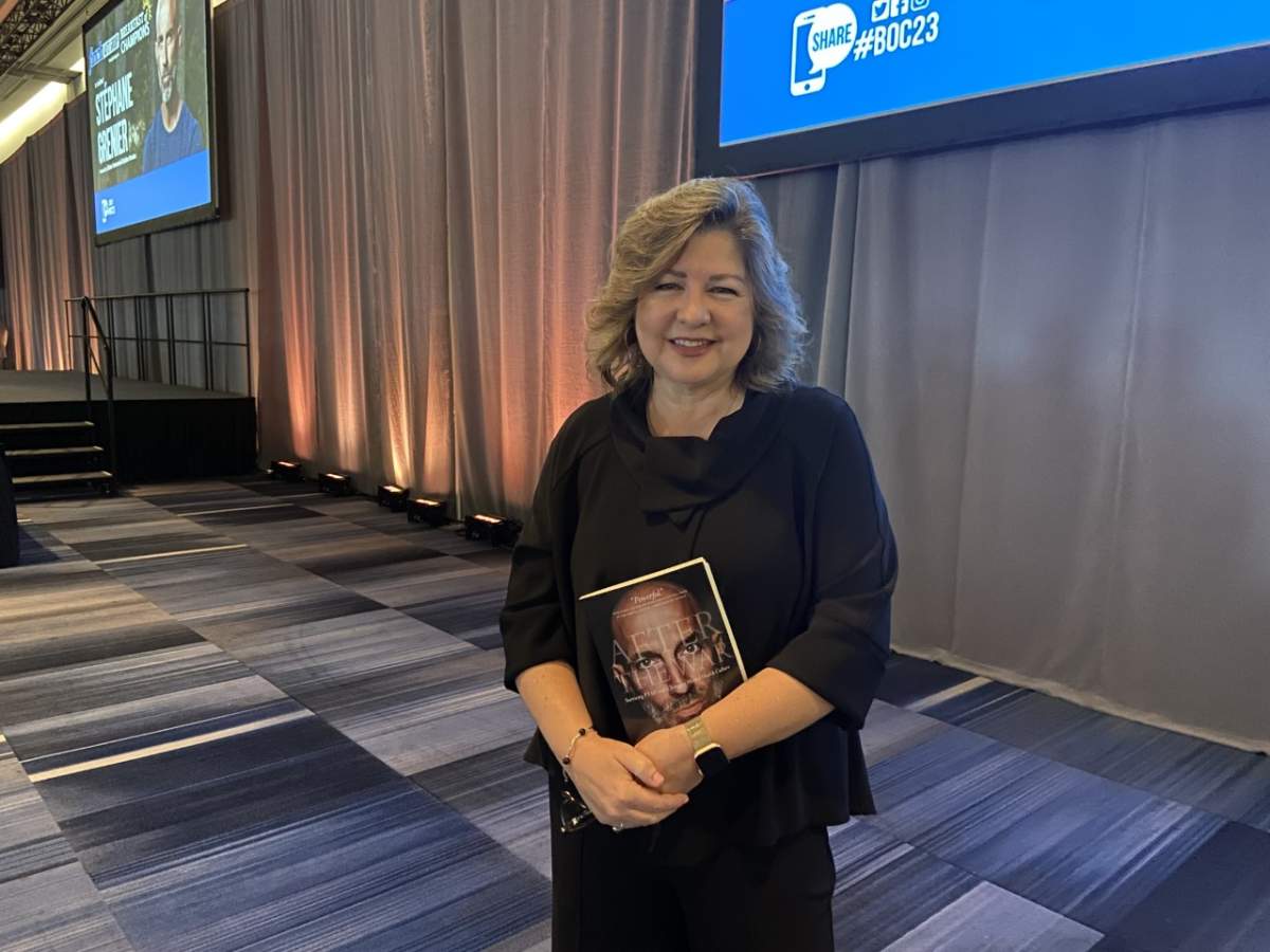 Michelle Campbell, St. Joeseph’s Health Care Foundation president and CEO, holding a copy of ‘After the War: Surviving PTSD and Changing Mental Health Culture,’ by retired lieutenant colonel Stéphane Grenier.