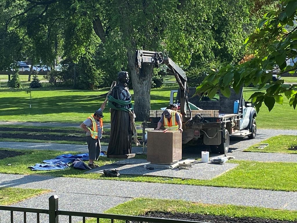 Workers reinstall a statue of Queen Elizabeth that was toppled on Canada Day 2021 on the grounds of the Manitoba legislature in Winnipeg on Friday June 2, 2023. 