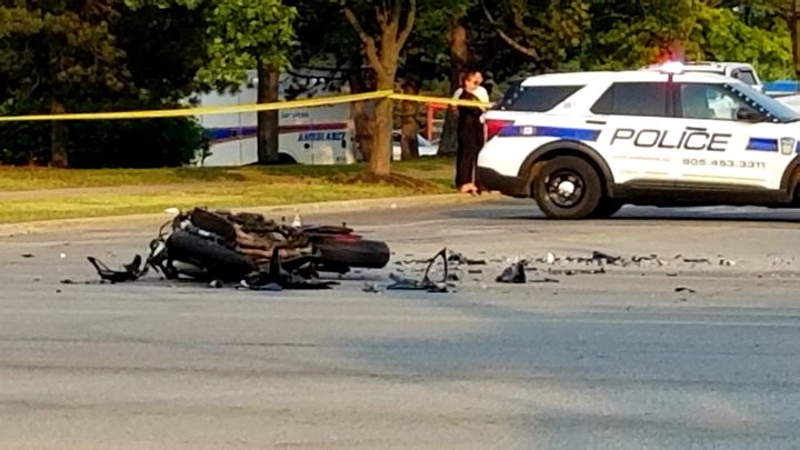 A Peel Regional Police cruiser on the scene of a collision involving a motorcycle.
