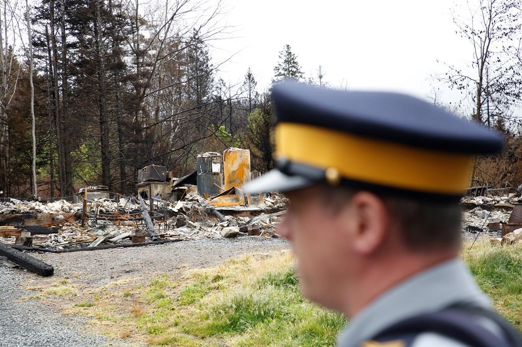 Municipal officials in the Halifax region say they will announce today when evacuation orders will be lifted for certain residents in subdivisions that sustained the most damage when a wildfire broke out on May 28 and eventually destroyed 150 homes. A police officer stands in front of the remains of a home destroyed by a wildfire in Hammond's Plains, N.S., during a media tour, Tuesday, June 6, 2023. THE CANADIAN PRESS/POOL, Tim Krochak