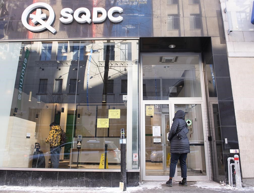 A person walks into an SQDC store in Montreal, Saturday, January 15, 2022. Quebec's cannabis subsidiary says its growth has plateaued for the first time despite the number of pot shops in the province increasing. THE CANADIAN PRESS/Graham Hughes.