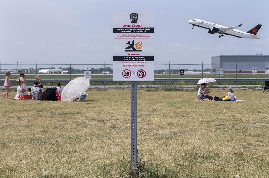 A sign warning people that the consumption of food is prohibited is shown at Jacques de Lesseps plane spotting park next to Trudeau Airport in Montreal, Sunday, June 11, 2023. 