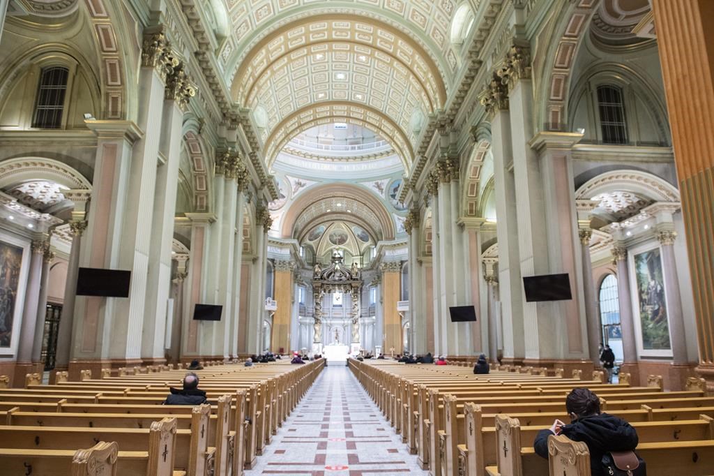 People attend mass at Mary Queen of the World Cathedral in Montreal, Monday, Feb. 7, 2022. The ombudswoman of Montreal's Roman Catholic archdiocese says she's seen an improvement in the handling of complaints since raising concerns about it last year. THE CANADIAN PRESS/Graham Hughes.