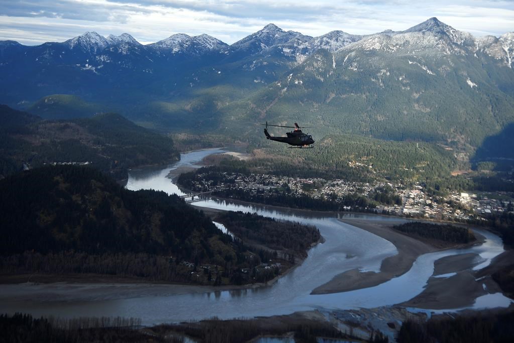 One of the three Royal Canadian Air Force helicopters surveys the Fraser Valley after rainstorms lashed the western Canadian province of British Columbia, triggering landslides and floods, shutting highways, near Abbotsford, B.C., Sunday, Nov. 21, 2021.