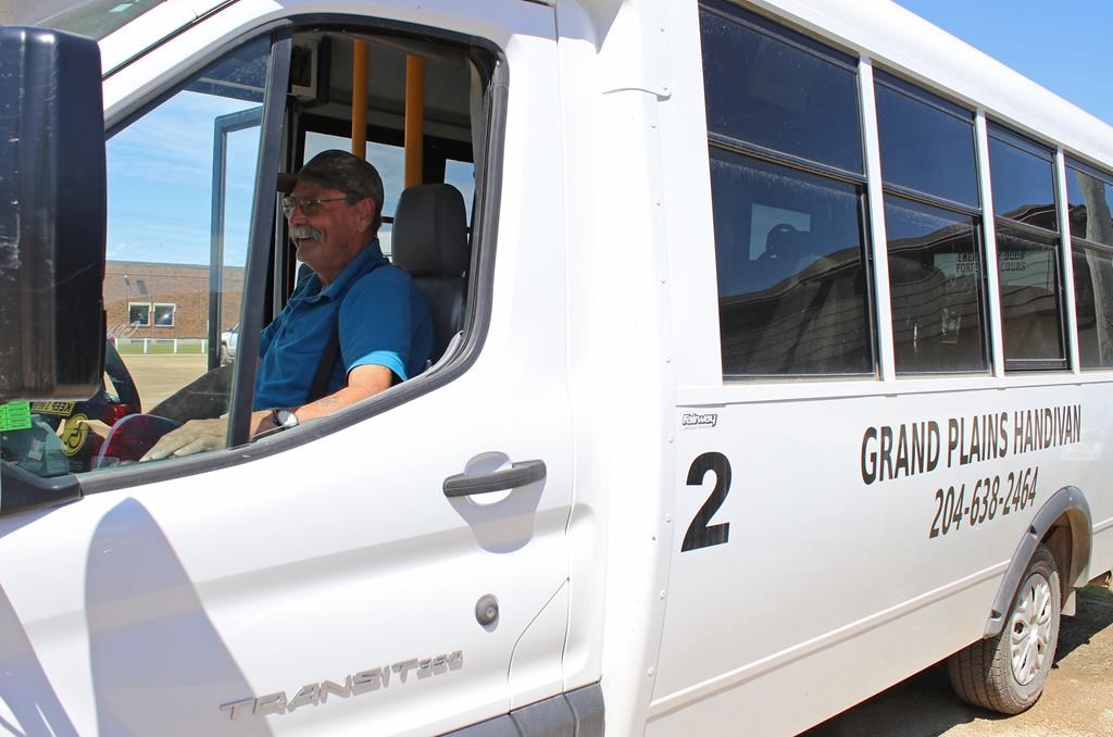 Doug Westhouse sits behind the wheel of a 12-passenger bus in Grandview, Man. on Tuesday. The coordinator and driver for Grand Plains Handivan transports people from Grandview and Gilbert Plains about 50 kilometres east to Dauphin for appointments, shopping and visits with family.