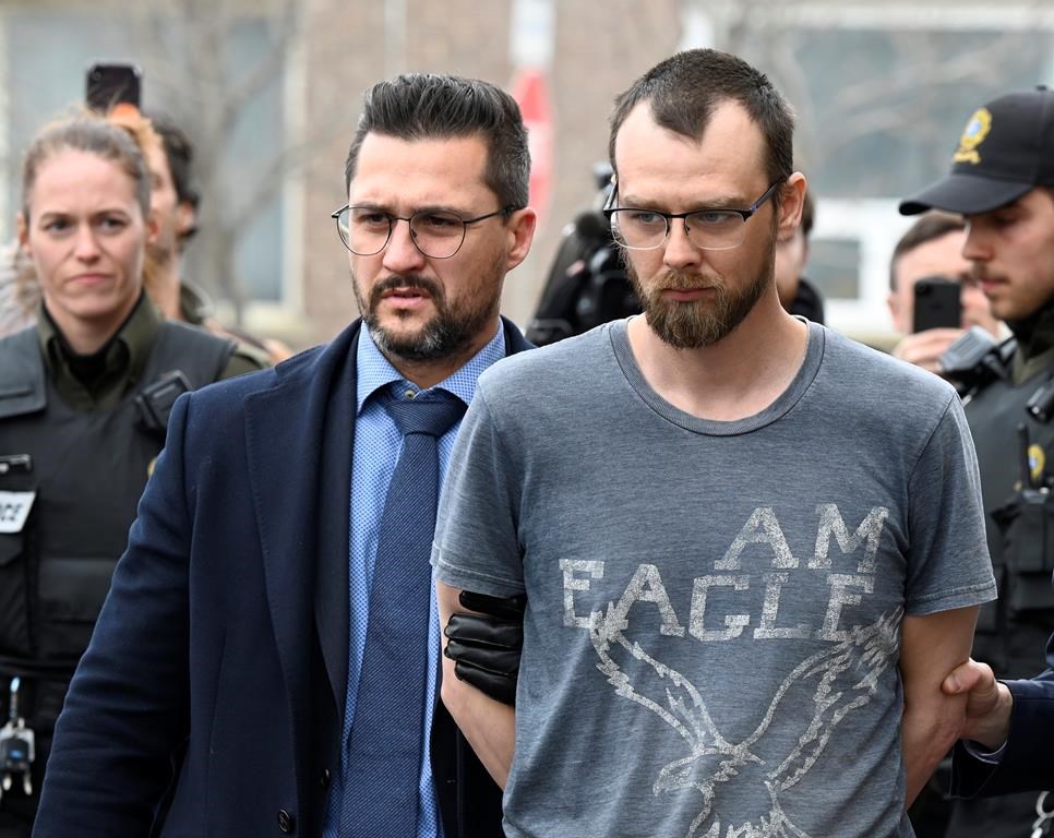 Steeve Gagnon is escorted by police out of court in Amqui, Que., Tuesday, March 14, 2023. Gagnon, a Quebec man accused of deliberately driving his truck into pedestrians in March, will have a preliminary hearing in September. THE CANADIAN PRESS/Jacques Boissinot.