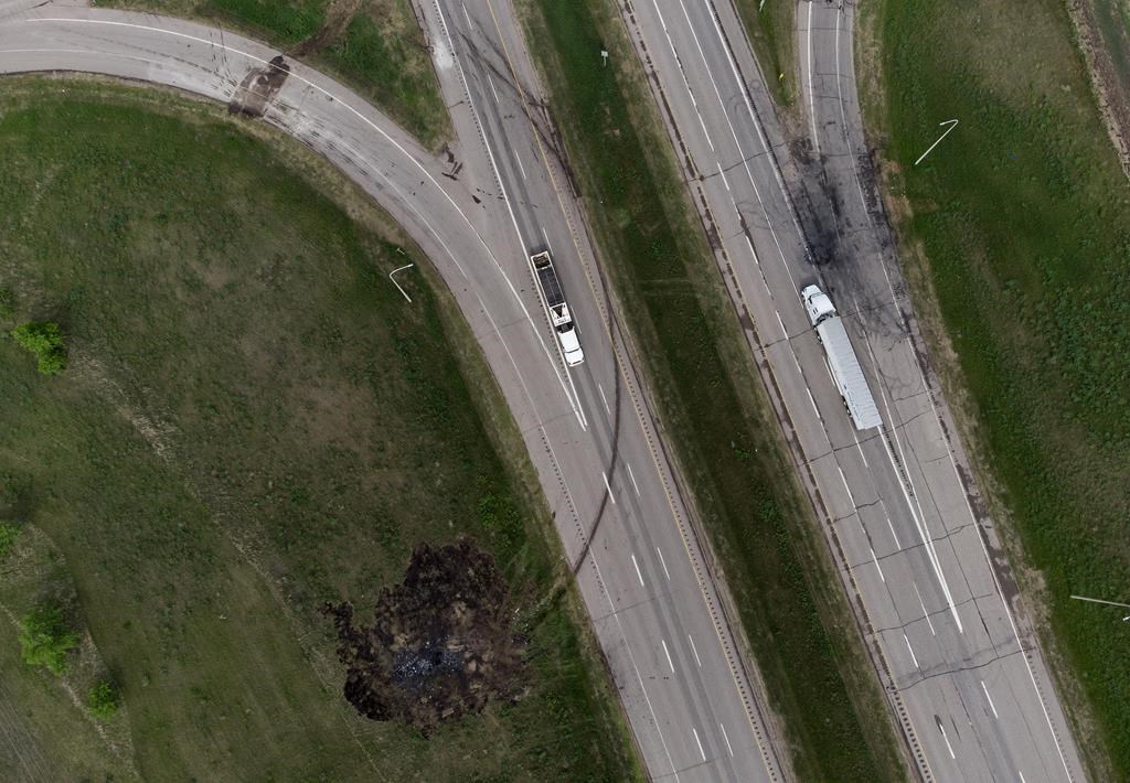 A scorched patch of ground where a bus carrying seniors ended up after colliding with a transport truck and burning on Thursday is seen on the edge of the Trans-Canada Highway where it intersects with Highway 5, west of Winnipeg near Carberry, Man., Friday, June 16, 2023.