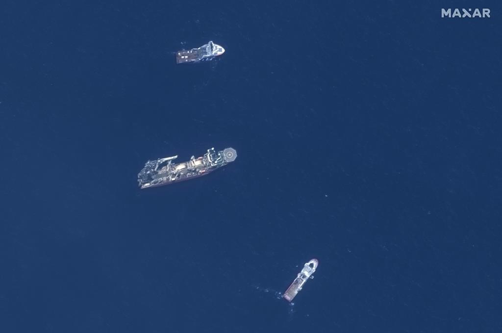 In this satellite image provided by Maxar Technologies, from top to bottom, the vessels Horizon Arctic, Deep Energy and Skandi Vinland search for the missing submersible Titan on June 22 in the Atlantic Ocean.