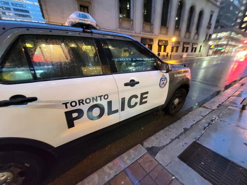 A Toronto police vehicle is shown parked on Yonge Street as rain falls in downtown Toronto on Tuesday Jan. 3, 2023. THE CANADIAN PRESS/Doug Ives.
