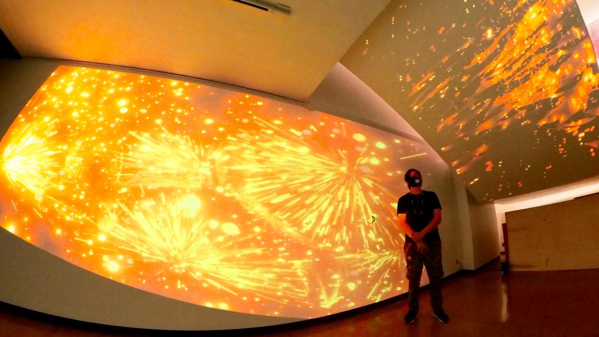 Casey Koyczan stands near one of his digital pieces.