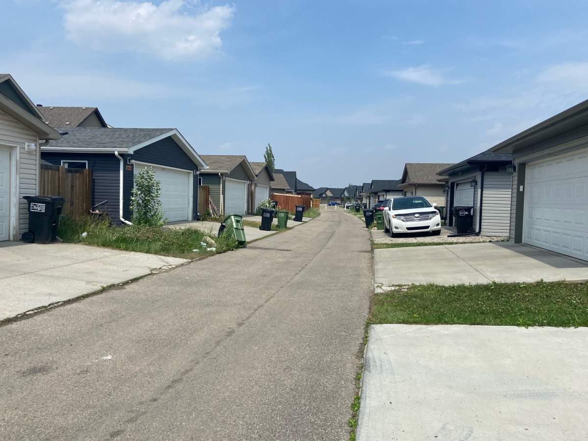 An alley between Allard Link and Arthurs Crescent in southwest Edmonton where a man's body was found on Monday, June 12, 2023.