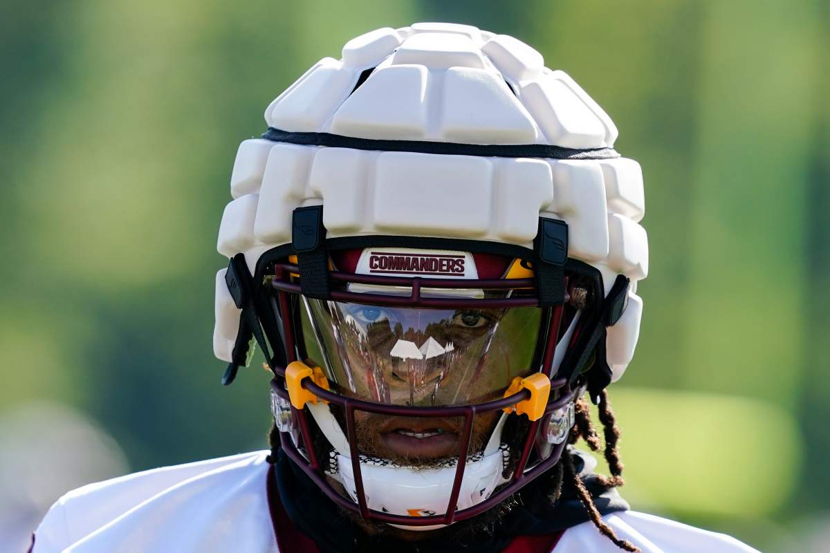 Washington Commanders running back Jonathan Williams wears a Guardian Cap football helmet during practice at the team's NFL football training facility, Wednesday, July 27, 2022 in Ashburn, Va.