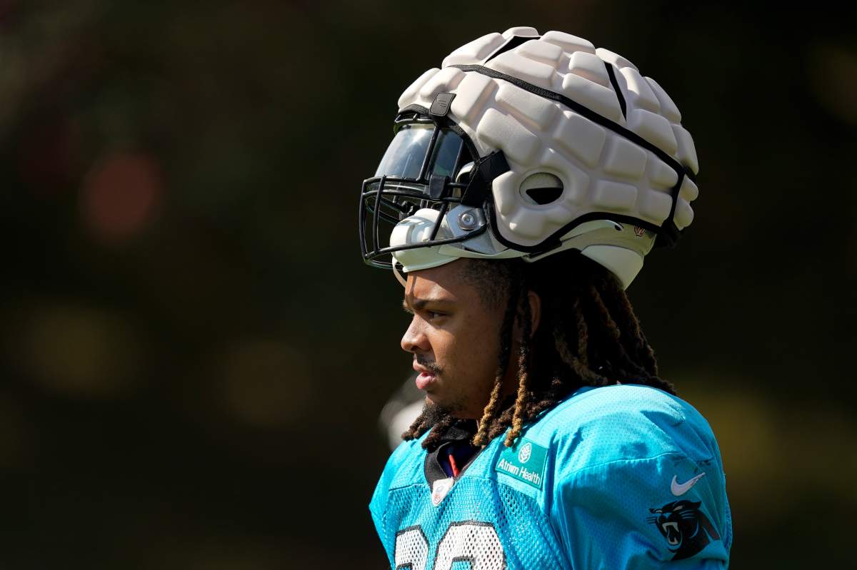 Carolina Panthers' Darryl Johnsonarrives for the NFL football team's training camp carrying his helmet with a protective covering at Wofford College on Wednesday, Aug. 3, 2022, in Spartanburg, S.C. The NFL has made the use of Guardian Caps mandatory up until the second week of the preseason for offensive and defensive lineman, linebackers and tight ends.