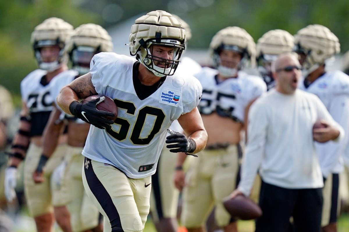 New Orleans Saints defensive end Scott Patchan (60) runs through drills during training camp at their NFL football training facility in Metairie, La., Thursday, Aug. 4, 2022. Guardian Caps, the mushroom-like contraptions NFL players are wearing on their helmets during training camp, are part of an ongoing safety experiment the league hopes will lead to a reduction in head injuries. Theyâ€™re now mandatory for all 32 NFL teams through the second preseason game, the time when the league says head injuries are most prevalent.