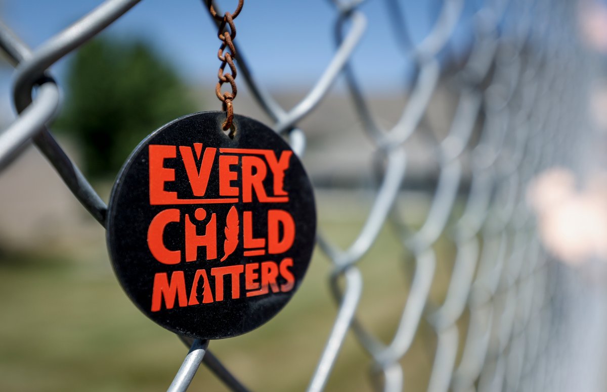 A key chain dangles from a fence as part of a memorial outside the former Kamloops Indian Residential School in Kamloops, B.C., Thursday, June 1, 2023. The remains of 215 children were discovered buried near the former Kamloops Indian Residential School in 2021.